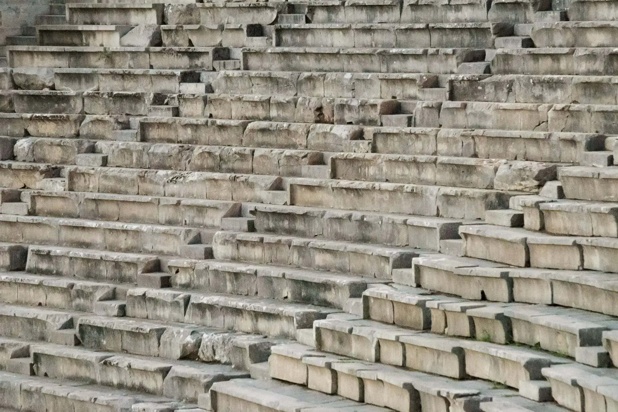 Rows of worn limestone seats in the theatre of Epidaurus